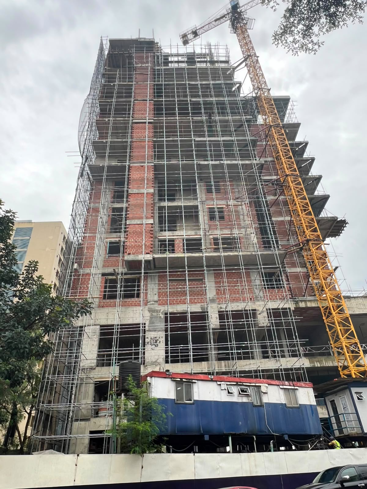Tower under construction with tower crane and scaffolding